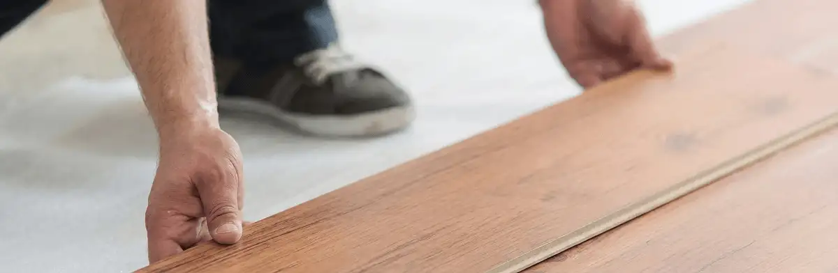 A professional installing laminate flooring in Cleveland, OH